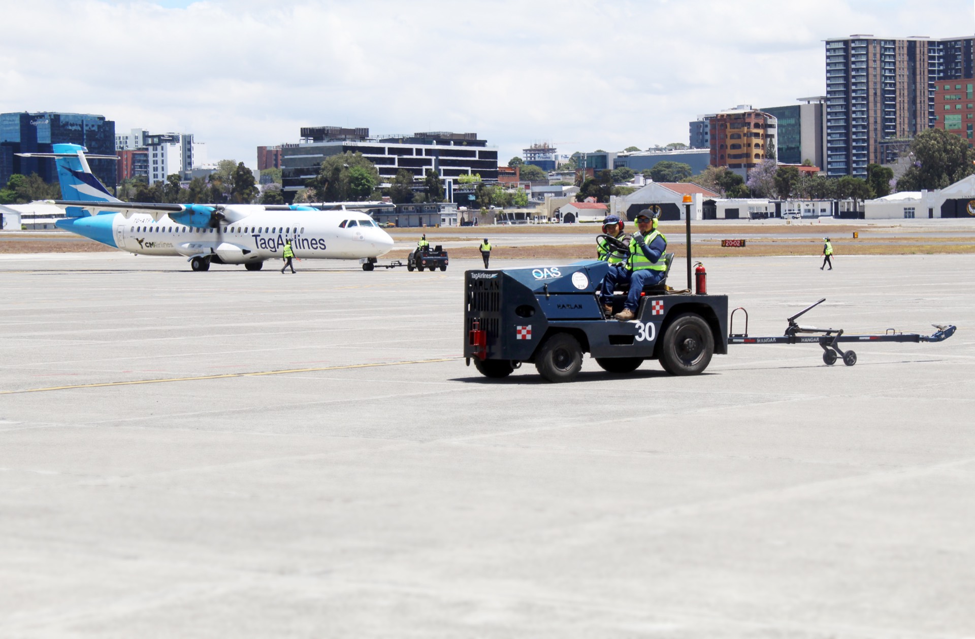 OAS Aviation ground crew operating pushback tractor at MGGT Guatemala